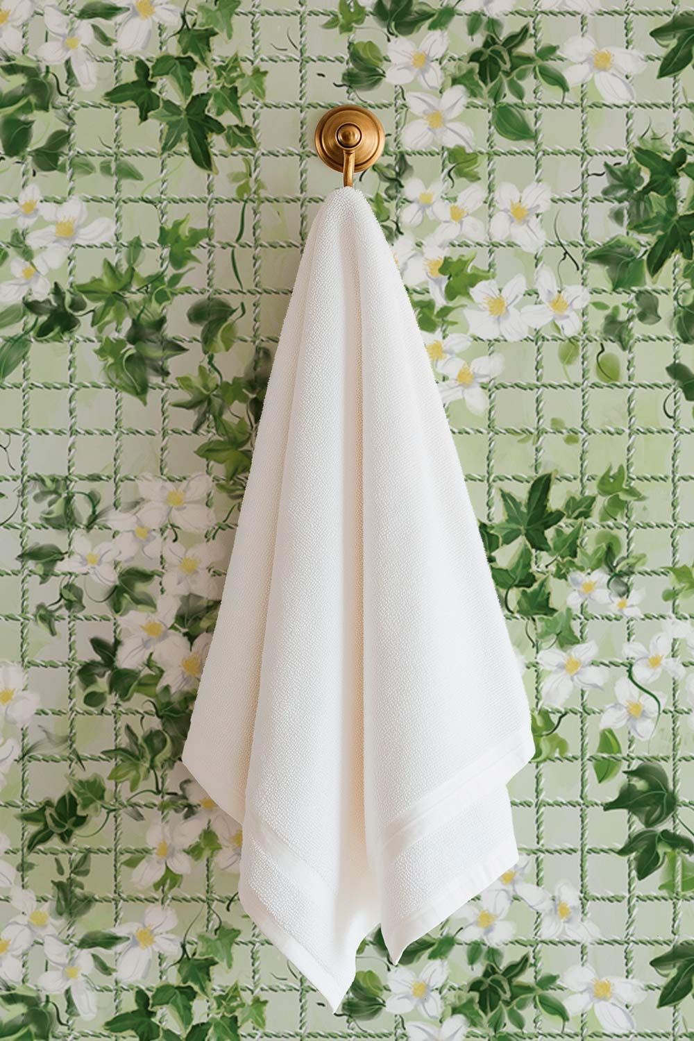 Performance vinyl wallpaper with watercolor ivy, white flowers, and a subtle tennis-net grid on a textured, washable surface in a fresh garden green color great for bathrooms, locker rooms because it is moisture resistant