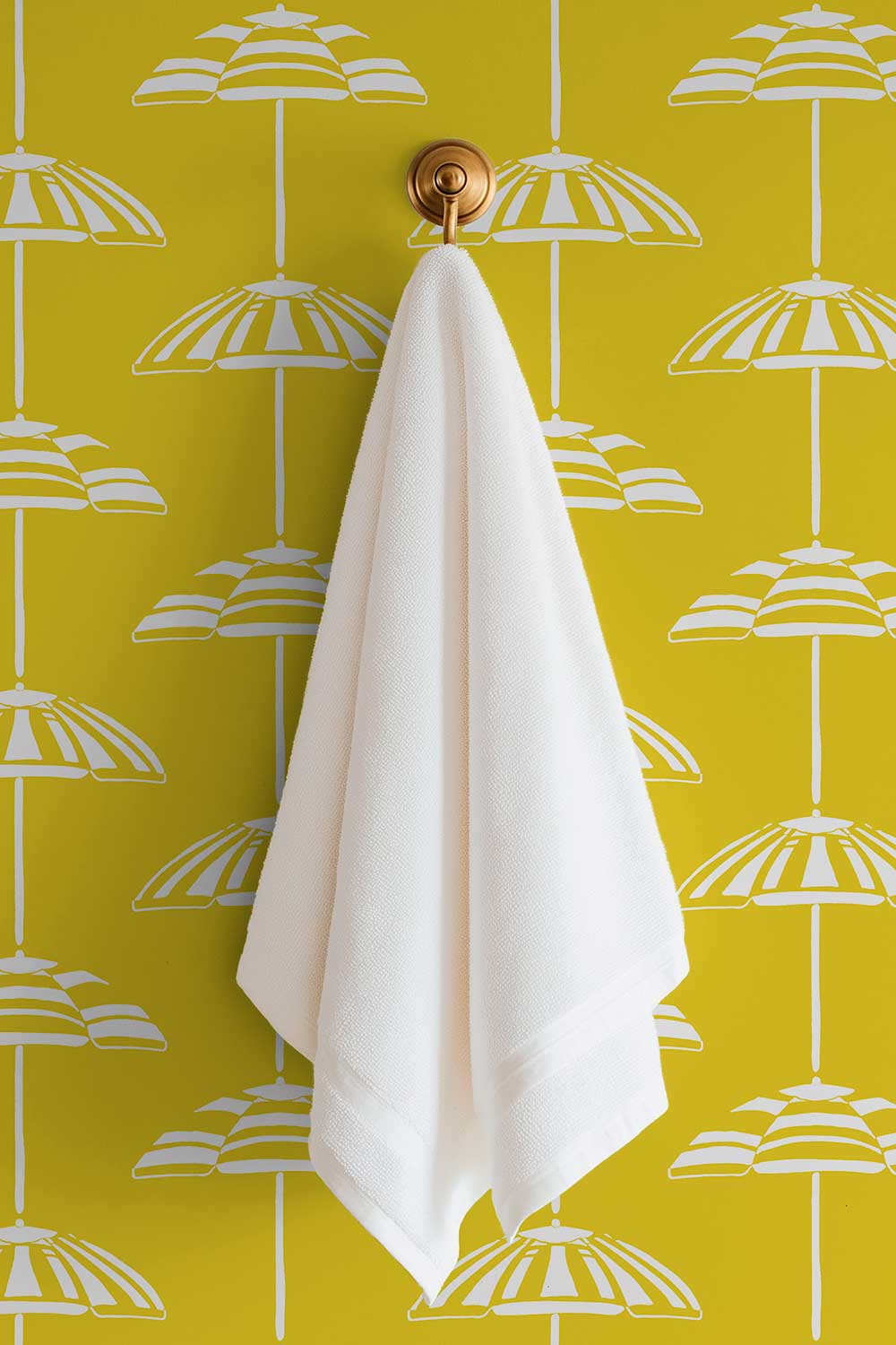 custom performance vinyl wallpaper that is washable and moisture repellant in bold pretty bright yellow and white beach umbrella stripes for interior designers and custom home builders of coastal beach homes perfect for bathrooms