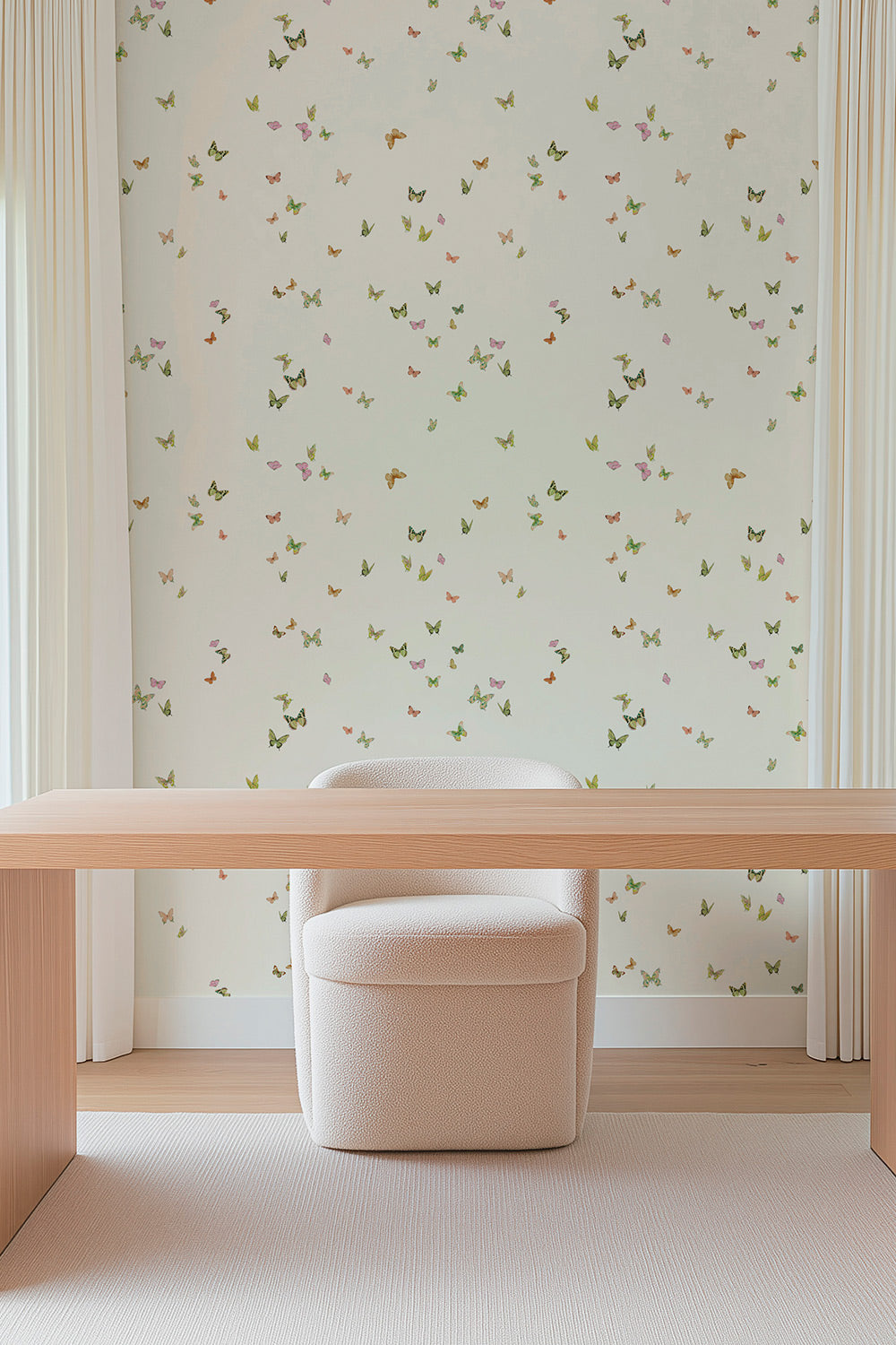 Butterfly Grove wallpaper featuring watercolor-painted butterflies in soft pink, green, and neutral tones inspired by English garden skies printed on a cream colored traditional wall-covering perfect for feminine home offices
