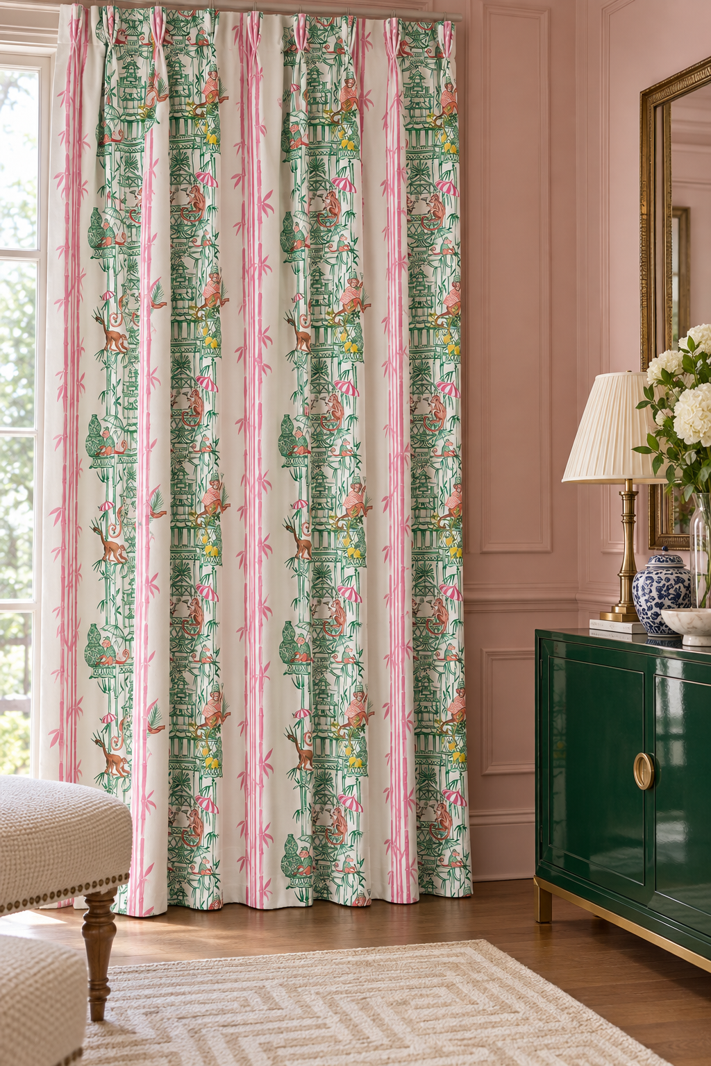 Whimsical chinoiserie toile upholstery fabric featuring pagodas, bamboo details, and monkeys partying in a hand-painted striped layout featured as the custom drapery in this upscale traditional home living room.