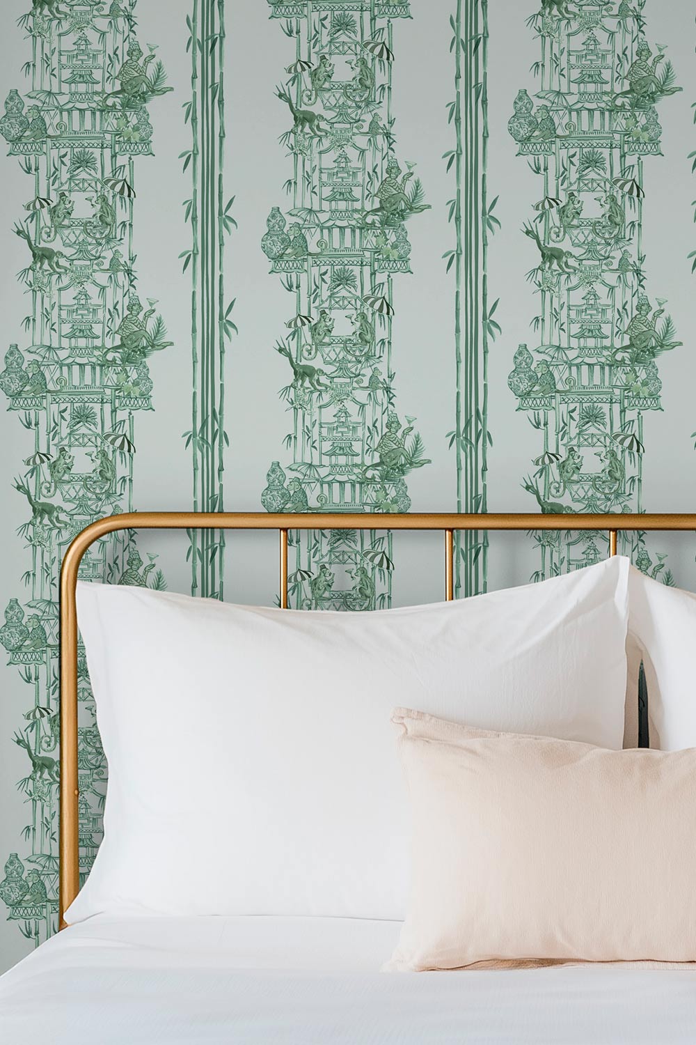 Hand-painted chinoiserie toile wallpaper on natural grasscloth featuring monkeys, pagodas, bamboo stripes, and whimsical party scenes in jade green, perfect for luxury master bedrooms