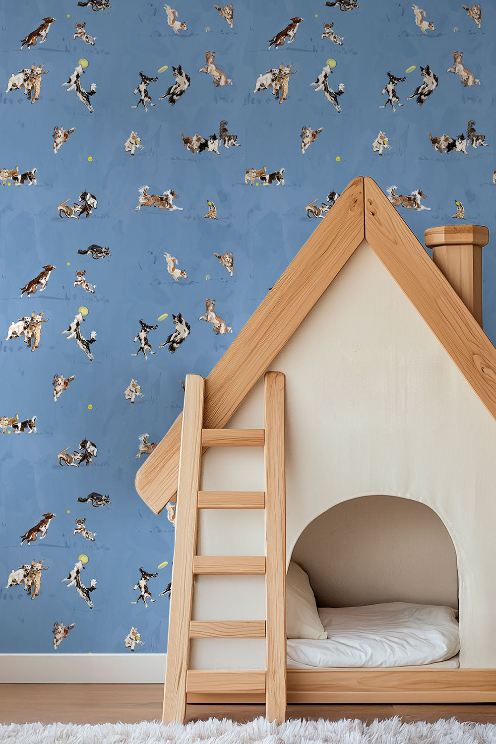 Hand-illustrated wallpaper featuring playful dogs in motion—jumping, chasing balls, wrestling and running—shown in multiple colorways including blue, tan, and green.
