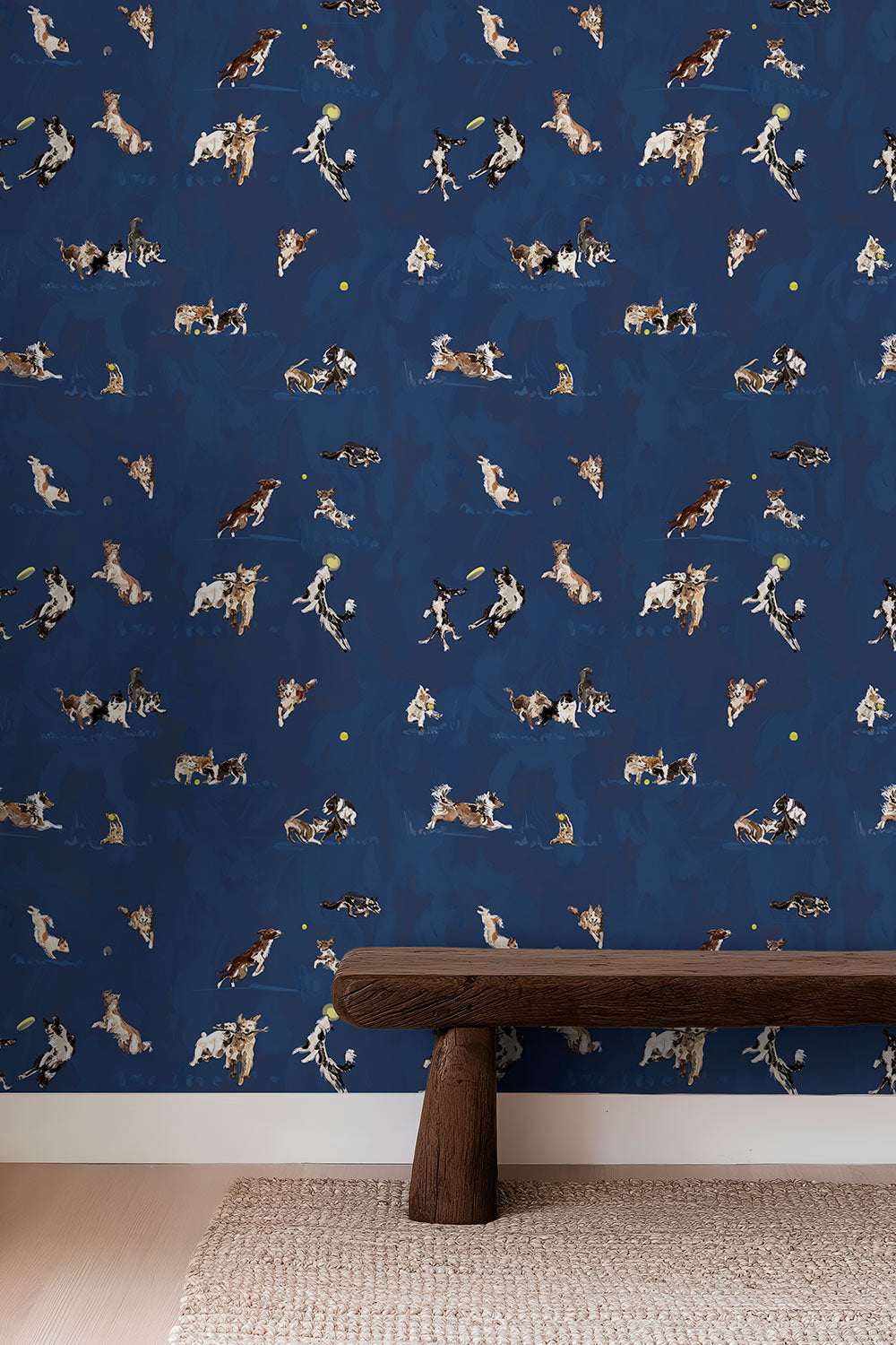 Hand-illustrated wallpaper featuring playful dogs in motion—jumping, chasing balls, wrestling and running—shown in multiple colorways including blue, tan, and green perfect for fun kids bedrooms, bathrooms and playrooms