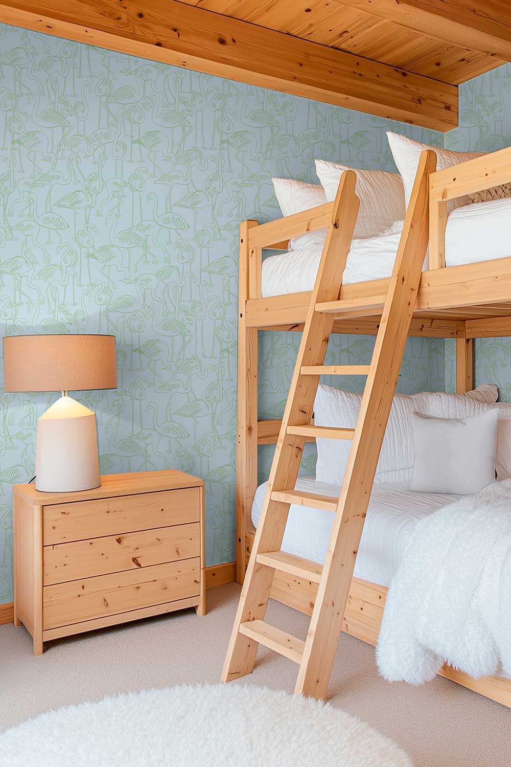 coastal kids gender neutral bunk room bedroom with tropical blue and green flamingo wallpaper for vacation rental houses in performance vinyl washable wallpaper