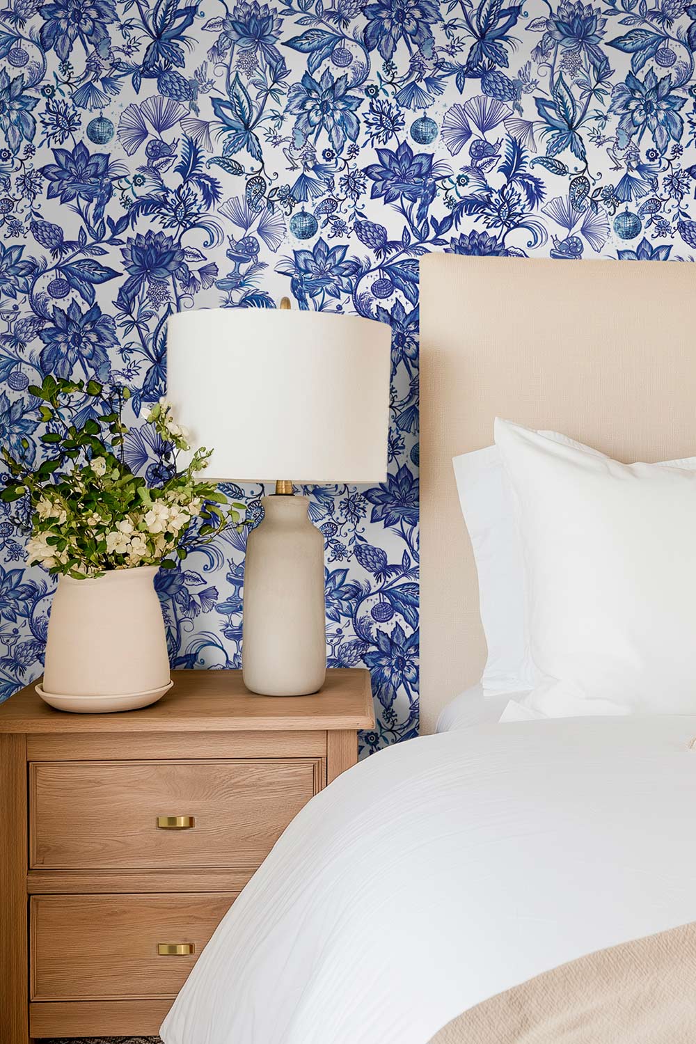 Watercolor chinoiserie wallpaper featuring lush florals, dancing frogs, snails, hummingbirds, and botanical motifs in a whimsical blue pattern perfect for fun and feminine guest bedrooms and girl's bedrooms