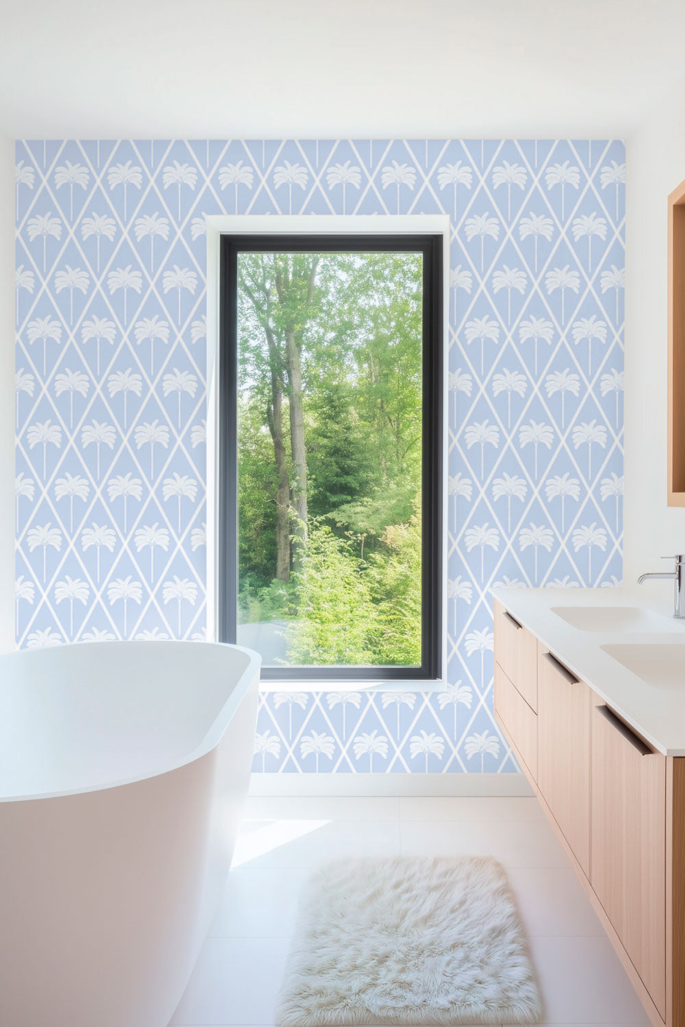washable and stain resistant performance vinyl wallpaper in french blue lattice design with geometric hand drawn palm trees for coastal homes seen here in this luxury guest bathroom