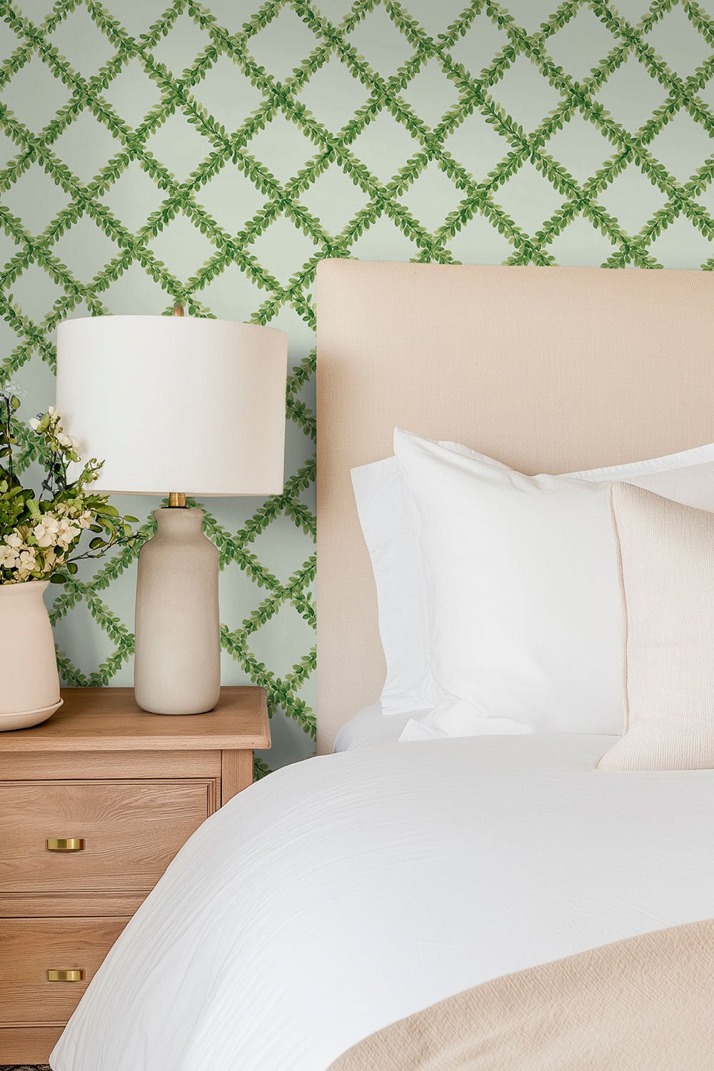Ivy Trellis grasscloth wallpaper featuring hand-painted green leafy diamonds on a woven natural fiber surface perfect for coming fresh bedrooms
