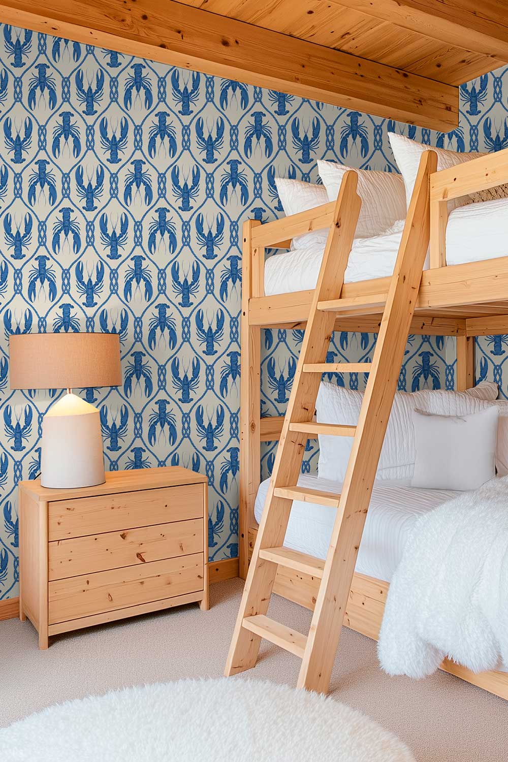 playful kids bunk room in coastal beach house with blue lobster geometric printed wall-covering