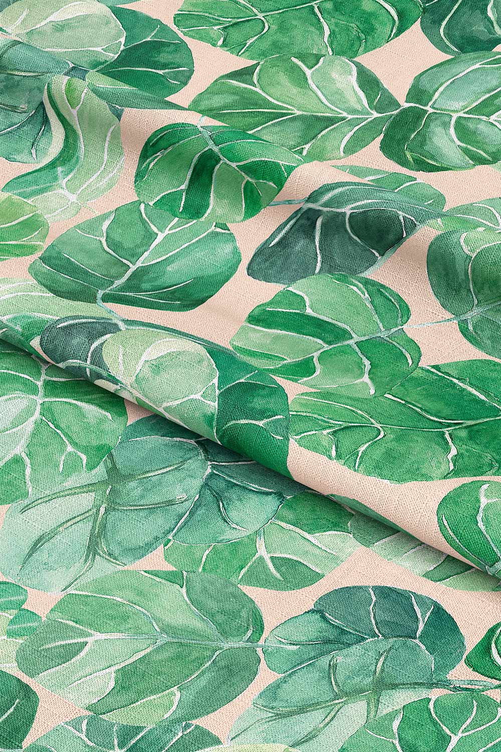 Tropical botanical upholstery fabric with large-scale hand-painted watercolor leaves in layered shades of green, inspired by coastal landscapes on light pink ground color.