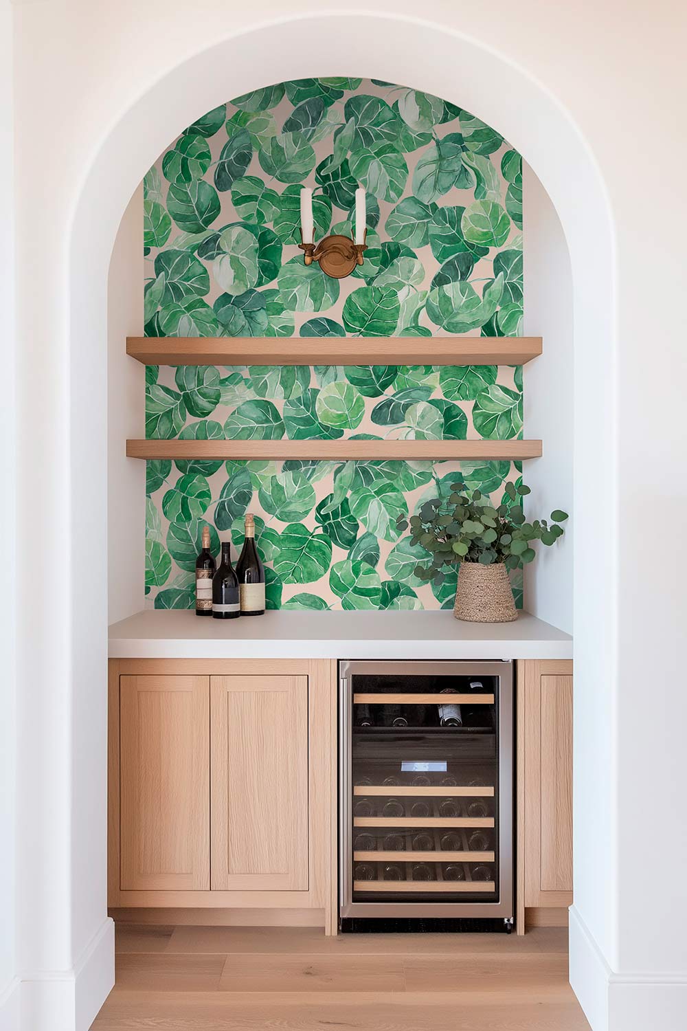 Textured performance vinyl wallpaper featuring large-scale watercolor tropical leaves in layered greens, available in multiple coastal base colors.