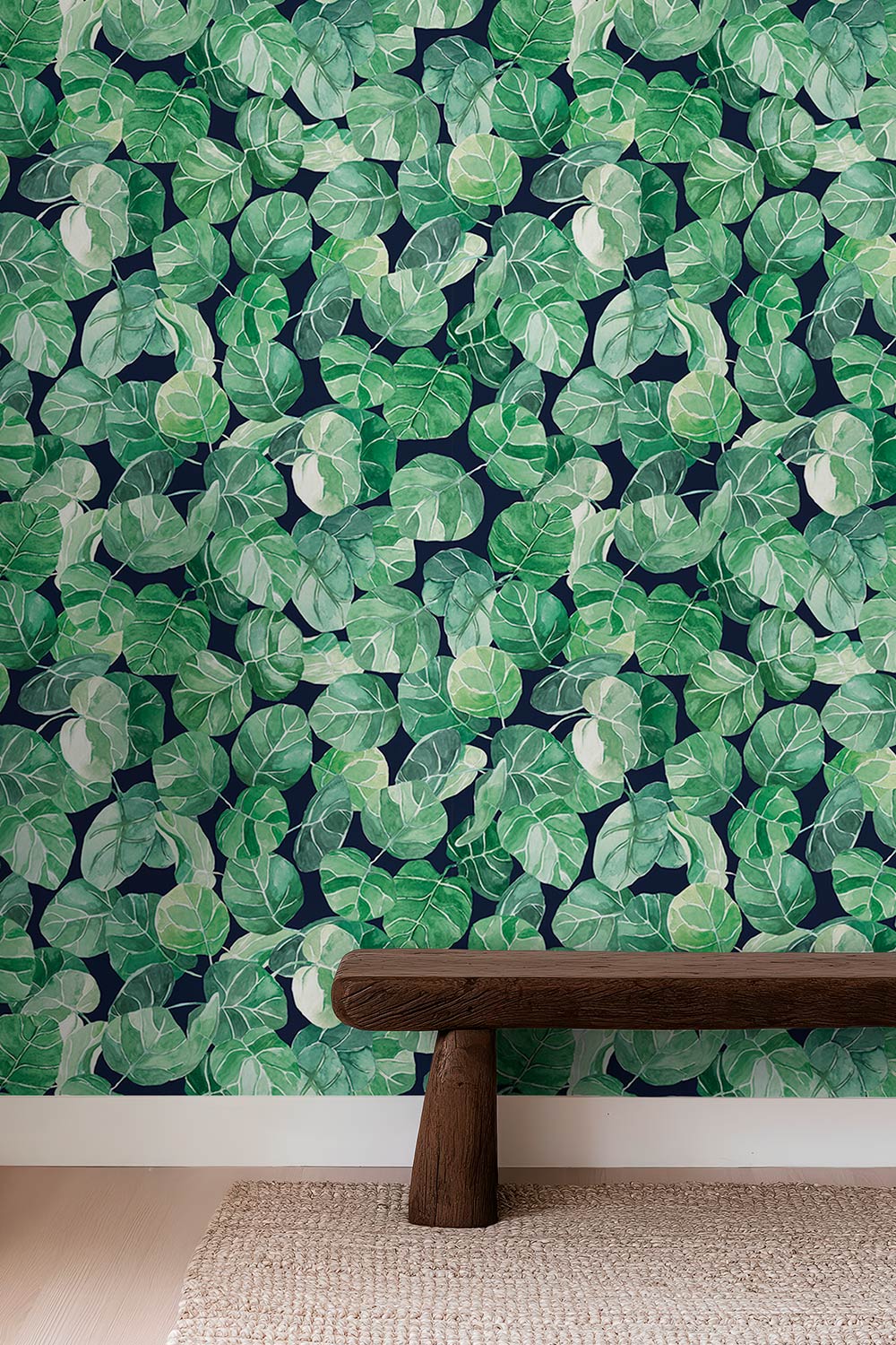 Watercolor leafy botanical wallpaper with layered tropical leaves in green hues, shown in navy, white, peach, and light blue backgrounds.