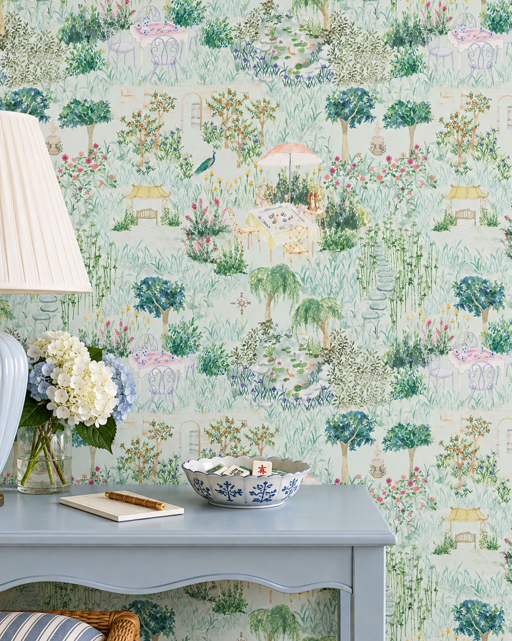 Mahjong Garden Toile peel and stick wallpaper in Trellis Green featuring a mahjong table, garden fountain, koi pond, flowers, bamboo and winding paths featured in this luxurious dining room