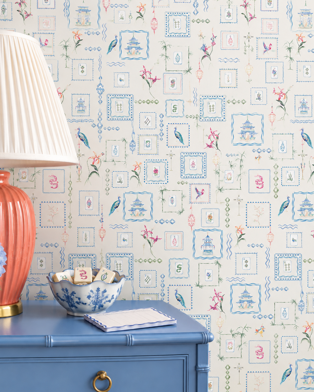 Hand-painted watercolor Mahjong Tiles wallpaper featuring mahjong tiles, pagodas, bamboo, birds, ginger jars, lanterns, and chinoiserie artwork on an off-white background printed on an all-natural and eco-friendly grasscloth wall-covering.