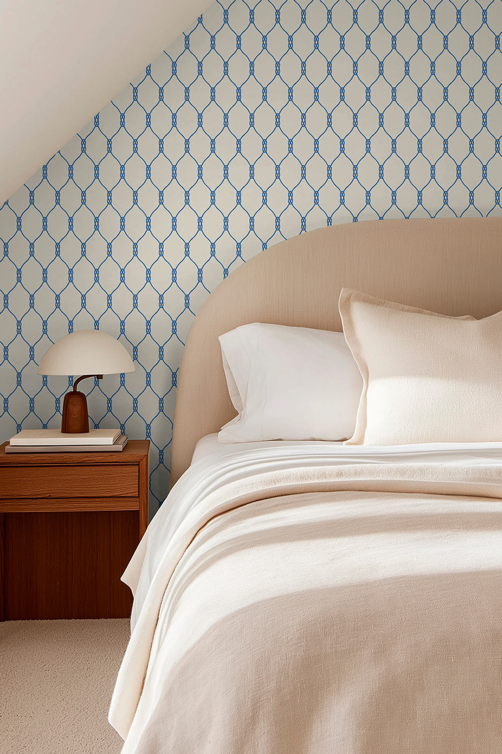 Grasscloth wallpaper featuring a repeating geometric rope-knot pattern illustrated in twisted rope lines over a woven natural fiber surface in classic nautical white and blue perfect for cozy guest cottage bedrooms