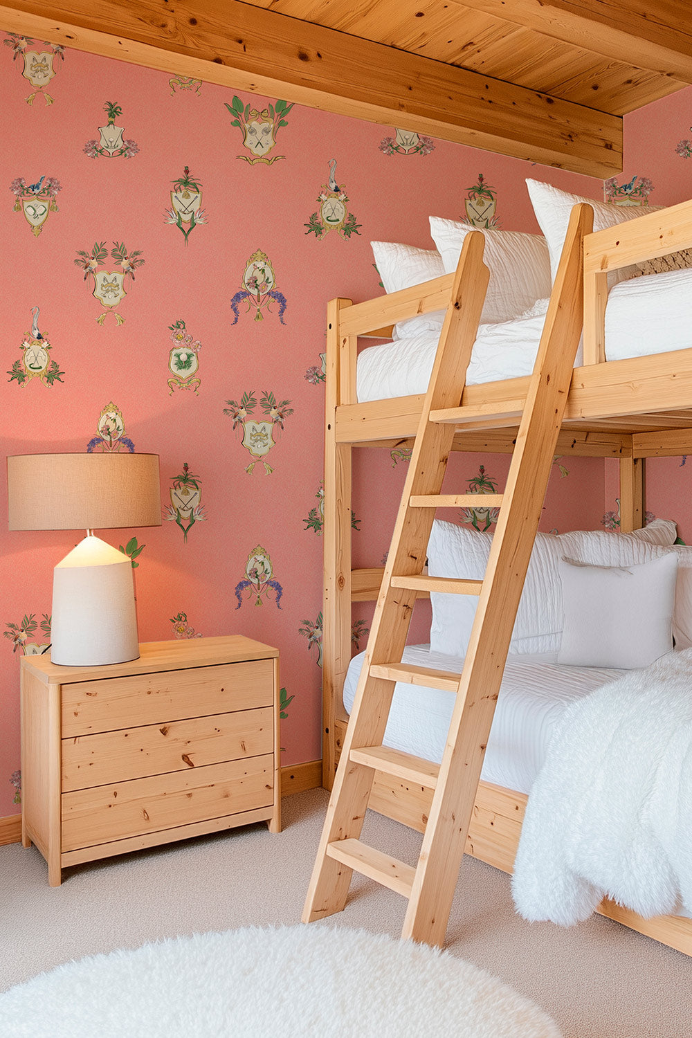 Country Club Crests washable performance vinyl wallpaper with tennis, golf and paddle crests, birds and florals on an pink coral background