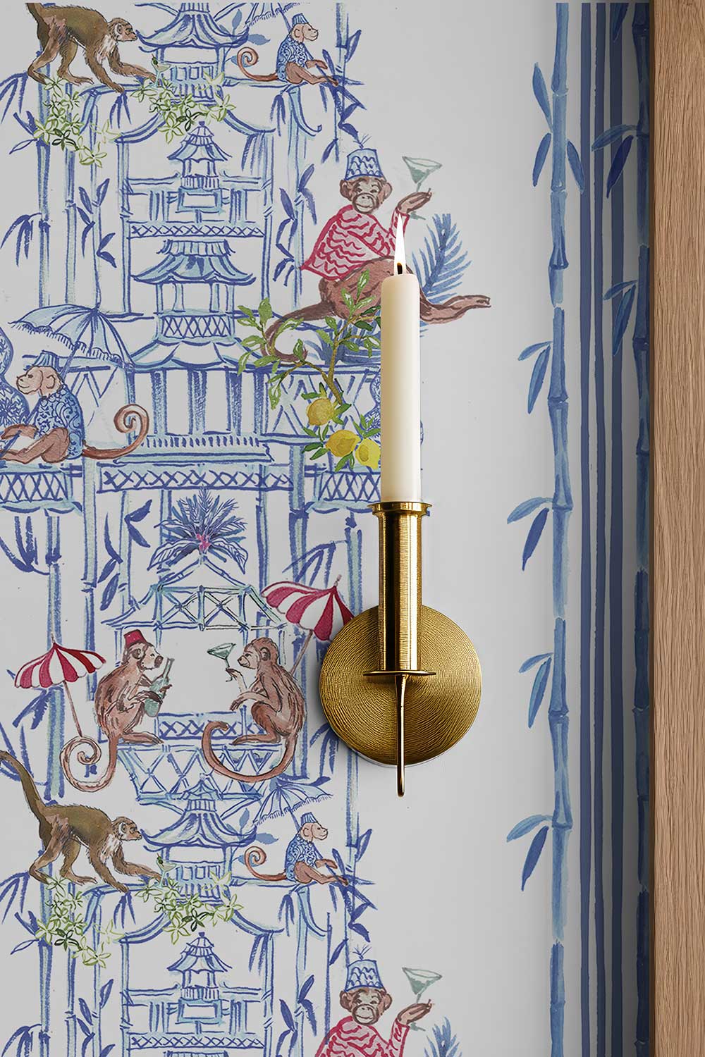 Chinoiserie Shenanigans peel and stick wallpaper in Azure Blue featuring playful monkeys, pagodas, bamboo, porcelain vases and red striped umbrellas.
