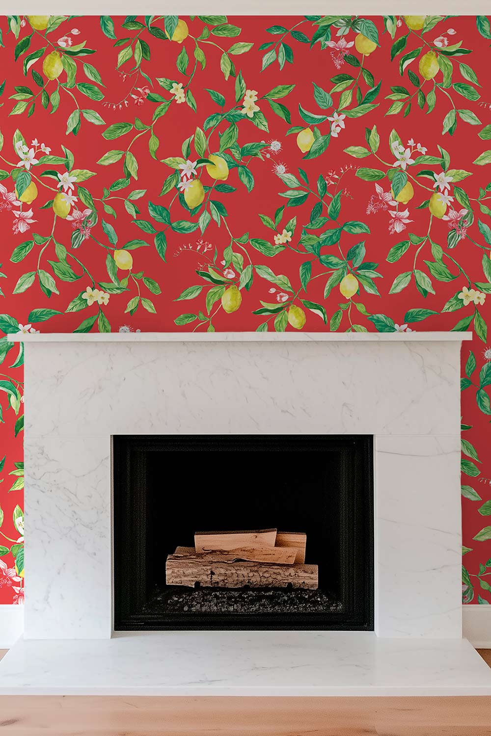 Red wallpaper with a green and yellow lemon tree pattern, shown behind a white marble fireplace mantel and black firebox. lemon wallpaper, citrus wallpaper, limoncello wallpaper, white and pastel wallpaper, fruit wallpaper, italian inspired wallpaper, kitchen wallpaper, lemon floral print on all-natural and eco-friendly wall-covering grasscloth and paperweave