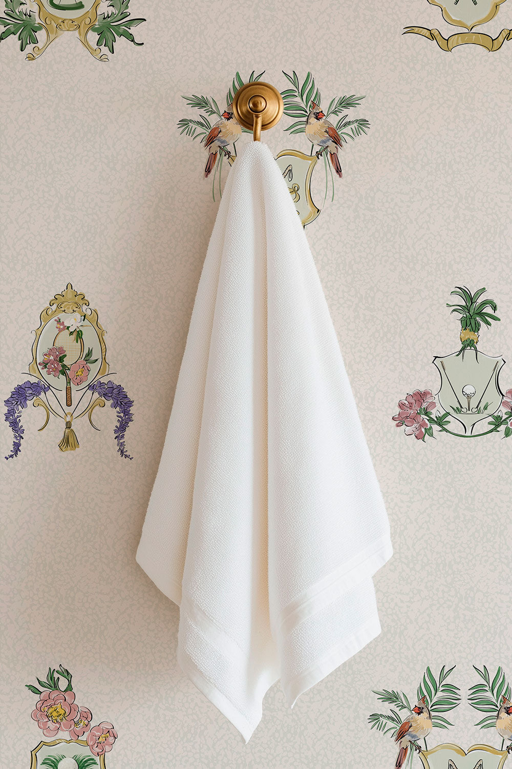 Country Club Crests washable performance vinyl wallpaper with tennis, golf and paddle crests, birds and florals on an neutral tan and white background