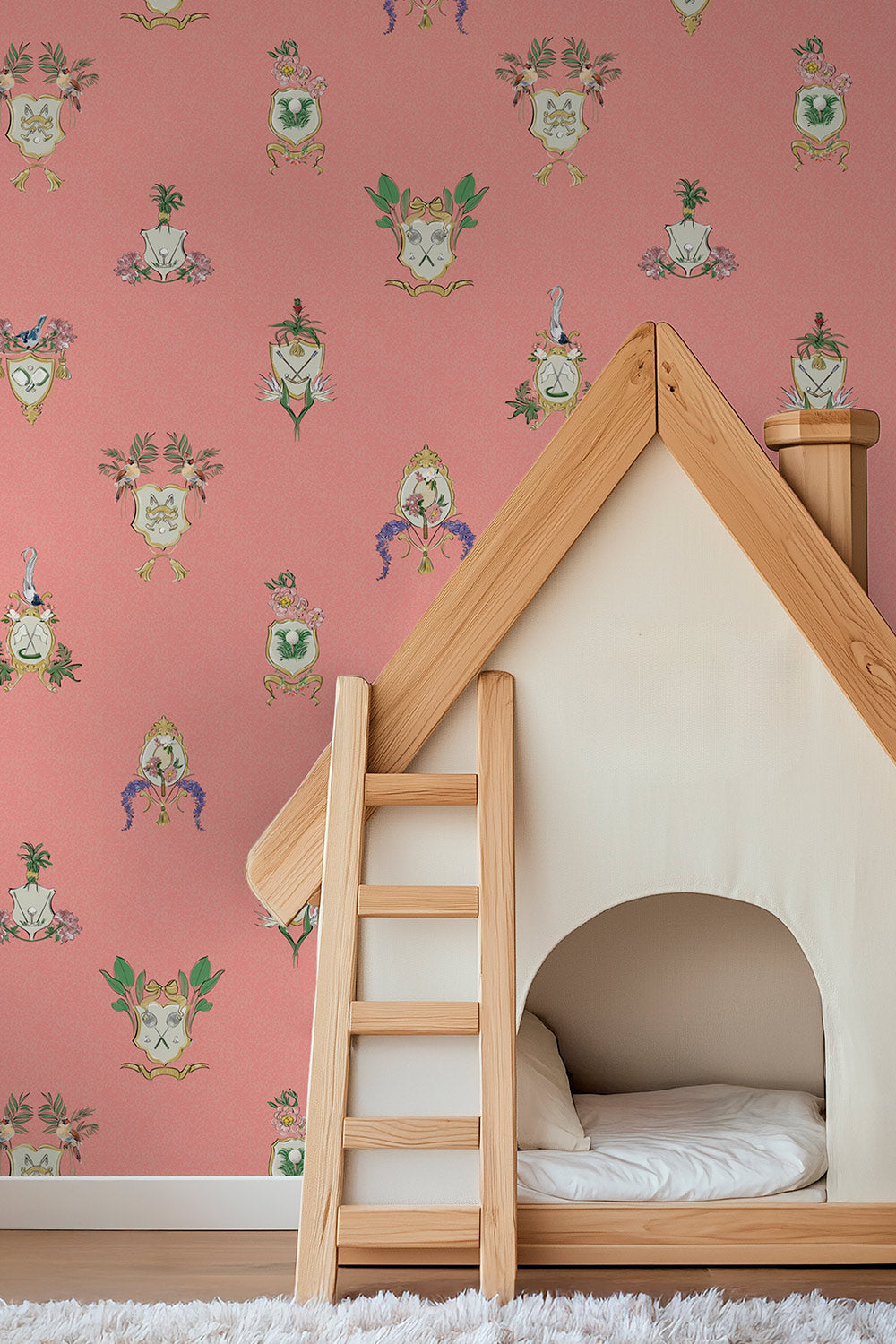 Country Club Crests traditional matte wallpaper with hand-painted tennis, golf and paddle crests, birds and florals on an bright coral background.