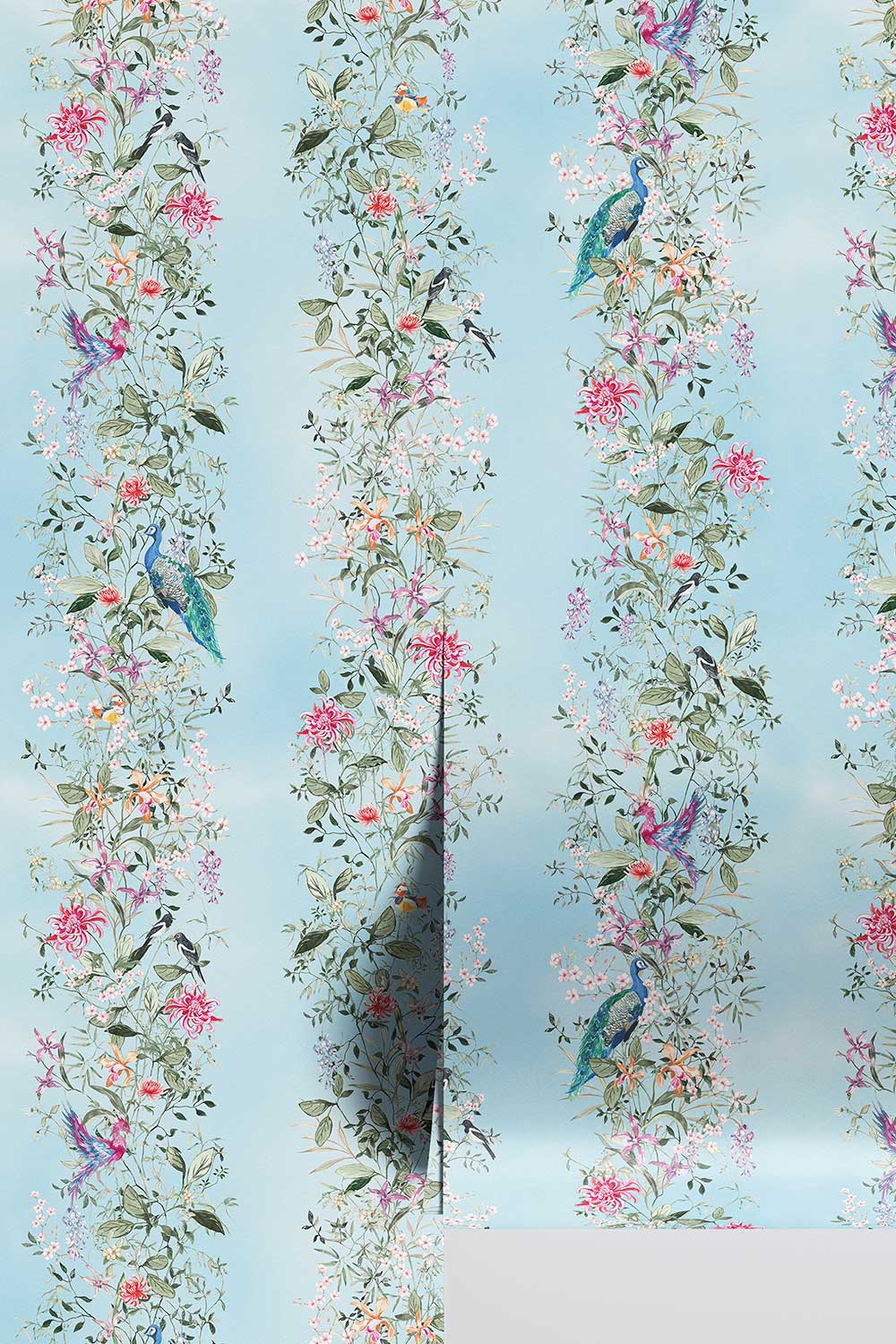 Hand-painted Mahjong Garden Stripe wallpaper featuring watercolor chinoiserie florals, peacocks, birds, bamboo, and botanical stripes on a soft blue background