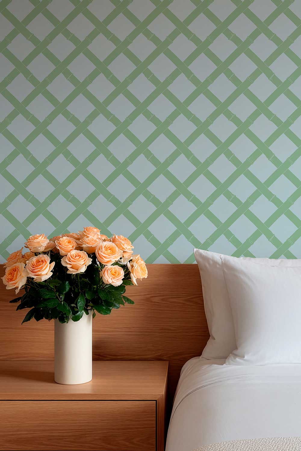 Tropicana Trellis removable peel and stick wallpaper in Cypress Garden featuring a geometric green bamboo lattice pattern on a soft light blue background featured in a cozy guest bedroom
