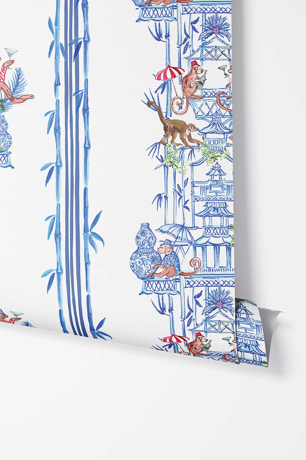 Chinoiserie Shenanigans peel and stick wallpaper in Azure Blue featuring playful monkeys, pagodas, bamboo, porcelain vases and red striped umbrellas.
