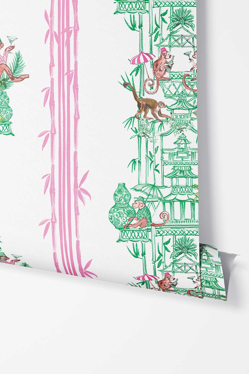 Chinoiserie Shenanigans removable peel and stick wallpaper in Bamboo Grove Green featuring playful monkeys, pagodas, porcelain vases and pink bamboo.