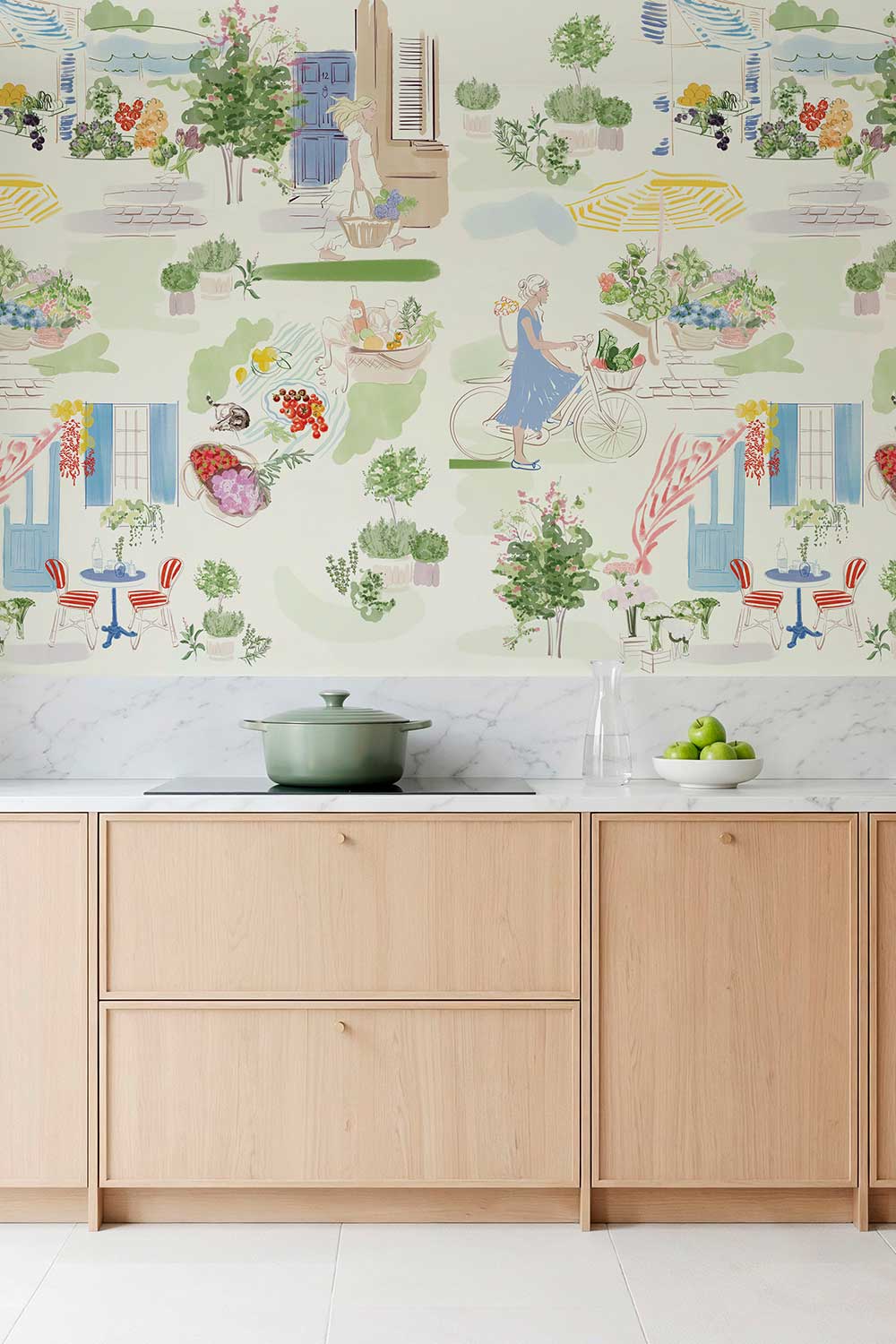 Farmer’s Market Toile peel and stick wallpaper in Morning Mint featuring a bicycle, flower stalls, fresh produce, potted herbs and a colorful French café.