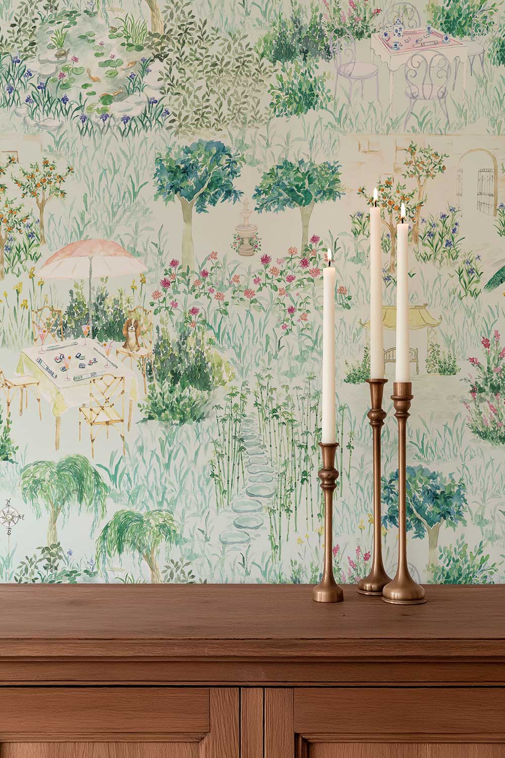 Mahjong Garden Toile peel and stick wallpaper in Trellis Green featuring a mahjong table, garden fountain, koi pond, flowers, bamboo and winding paths featured in this luxurious dining room