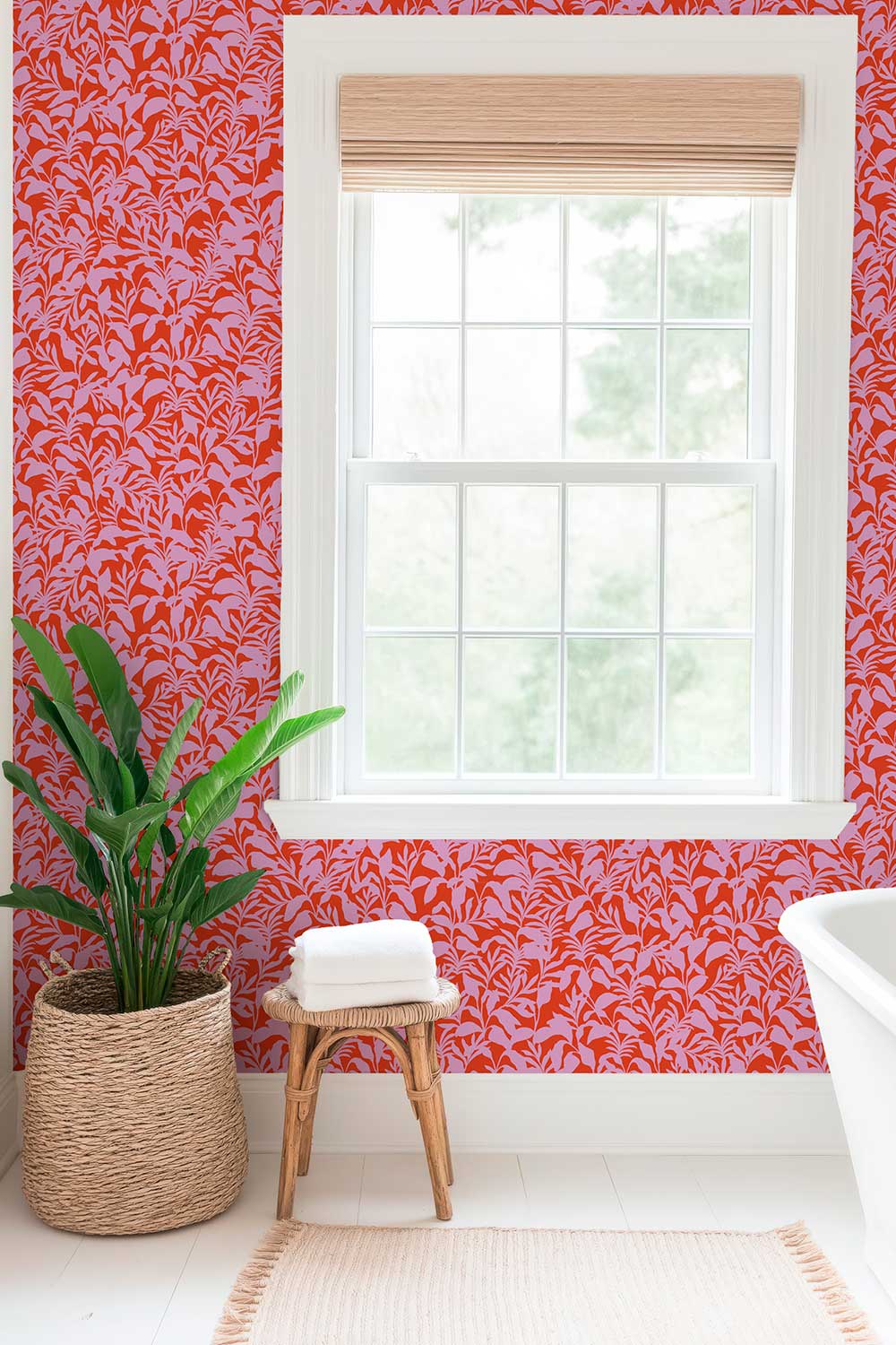 Playful palm frond wallpaper in bold colors for kids’ playroom bathrooms in bright red and pink leafy botanical.
