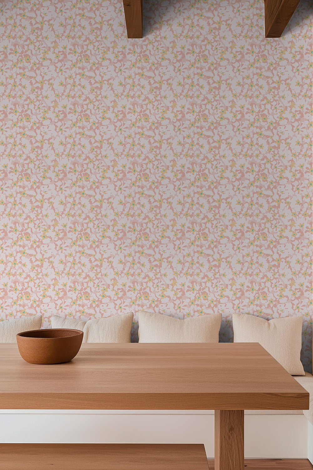 Pink botanical grass cloth wallpaper with soft vintage floral blooms in tightly packed pattern hung in cozy cottage breakfast nook