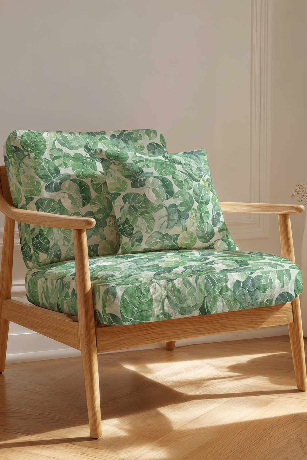 Coastal botanical upholstery fabric with oversized hand-painted sea grape leaves in layered watercolor greens on a light green base