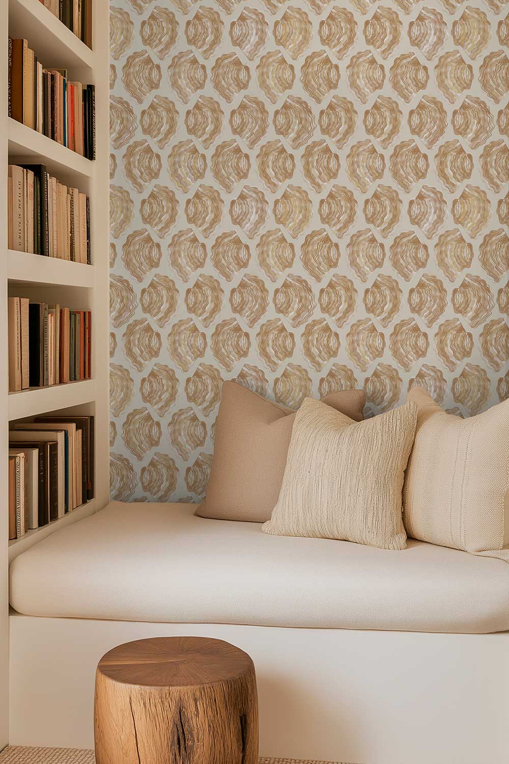 modern beach reading nook with window seat, books on a shelf, and watercolor seashell striped wallpaper