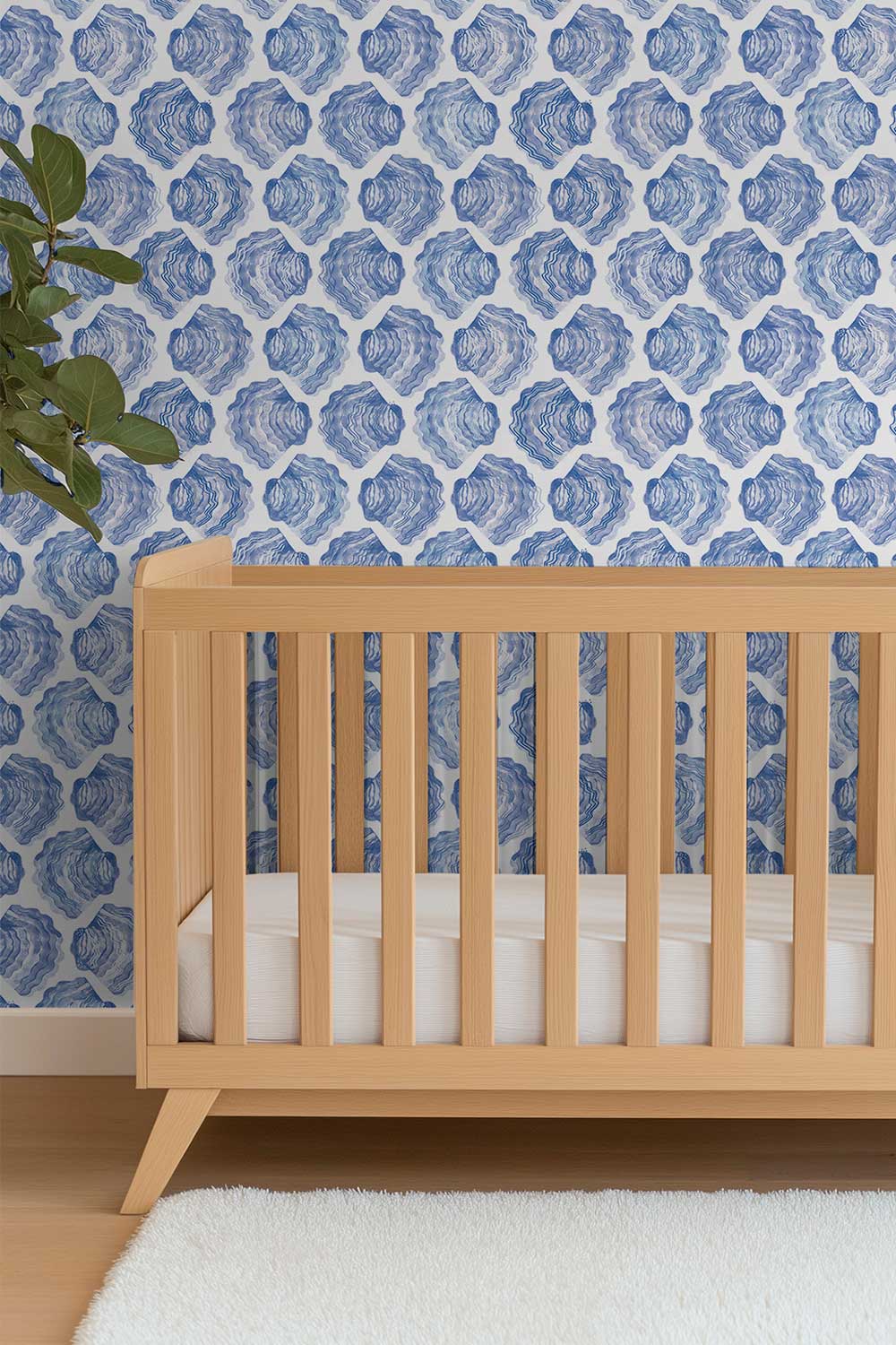 coastal inspired nautical baby nursery with watercolor blue striped seashell wallpaper