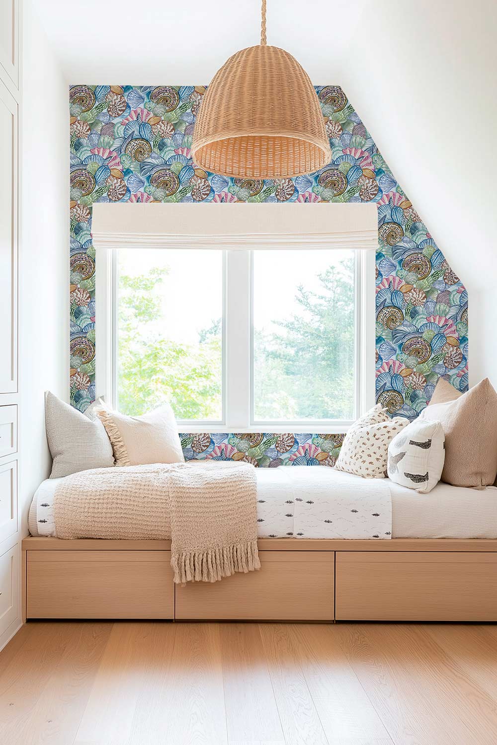 Hand-painted watercolor seashell collage wallpaper printed on natural grasscloth, featuring colorful layered shells in an artisanal coastal design perfect for coastal inspired kids bedrooms and plalyrooms