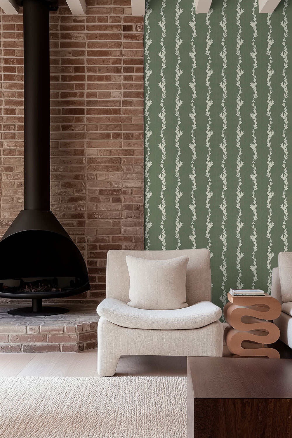 Modern living room with a brick wall, fireplace, and featuring elevated all-natural green grass cloth wall-covering in a botanical leaf stripe