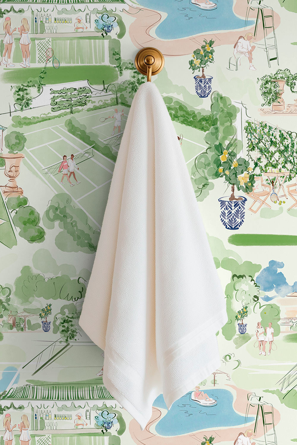 Tennis Club Toile performance vinyl wallpaper with illustrated tennis courts, gardens, poolside scenes, and cabana details on a textured washable surface