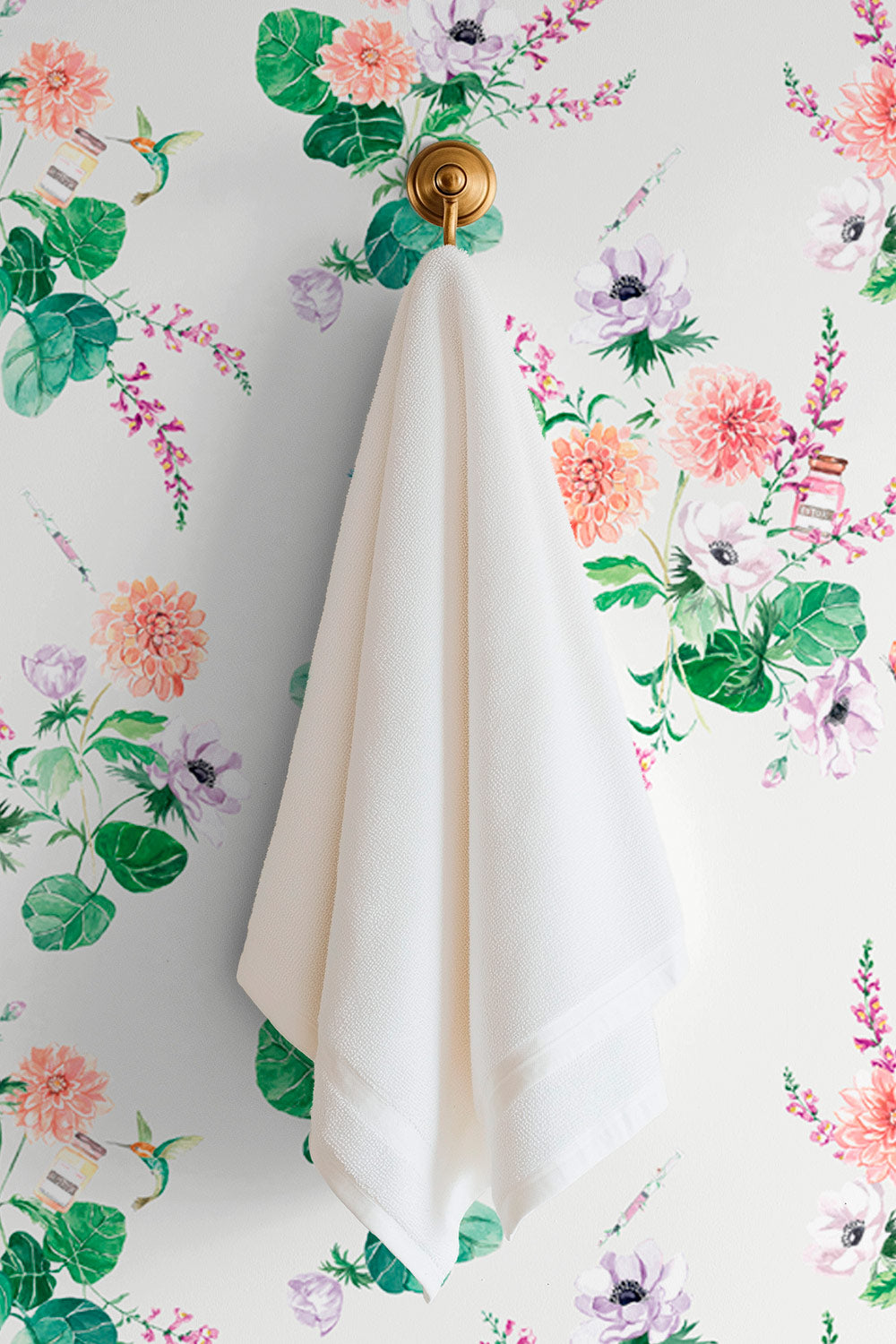 Walltox wallpaper featuring watercolor-painted florals with hidden Botox bottles, syringes, and hummingbirds in a whimsical luxury design printed on commercial grade water and stain resistant performance vinyl wall-covering, great for bathrooms, medspas and commercial spaces